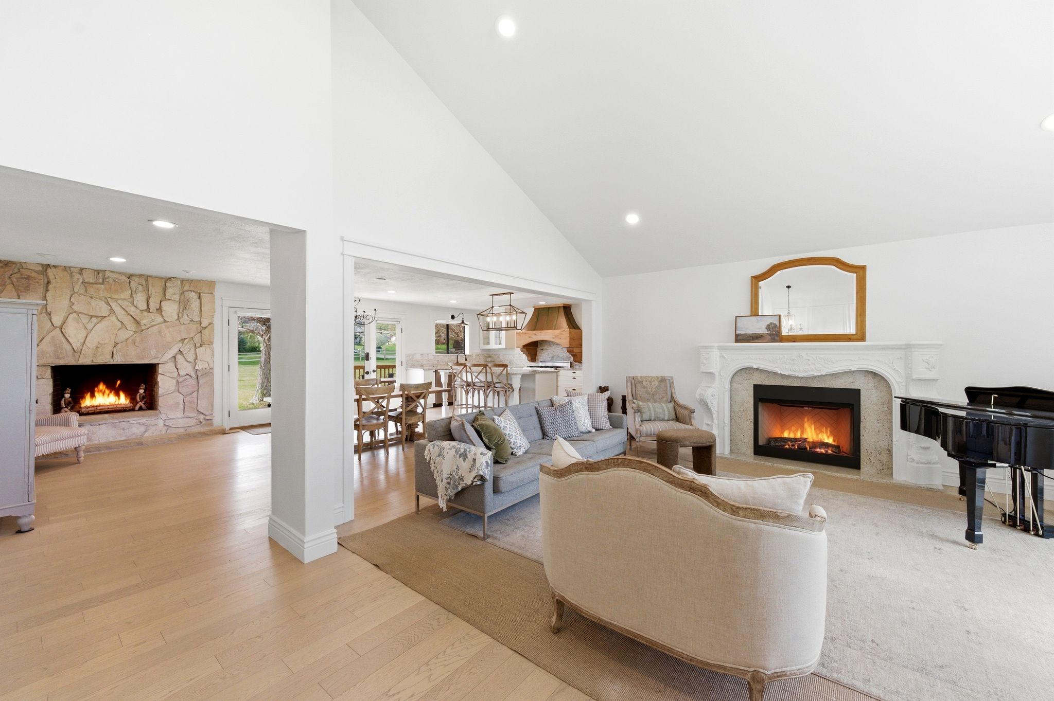 Vaulted great room with two fireplaces and grand piano